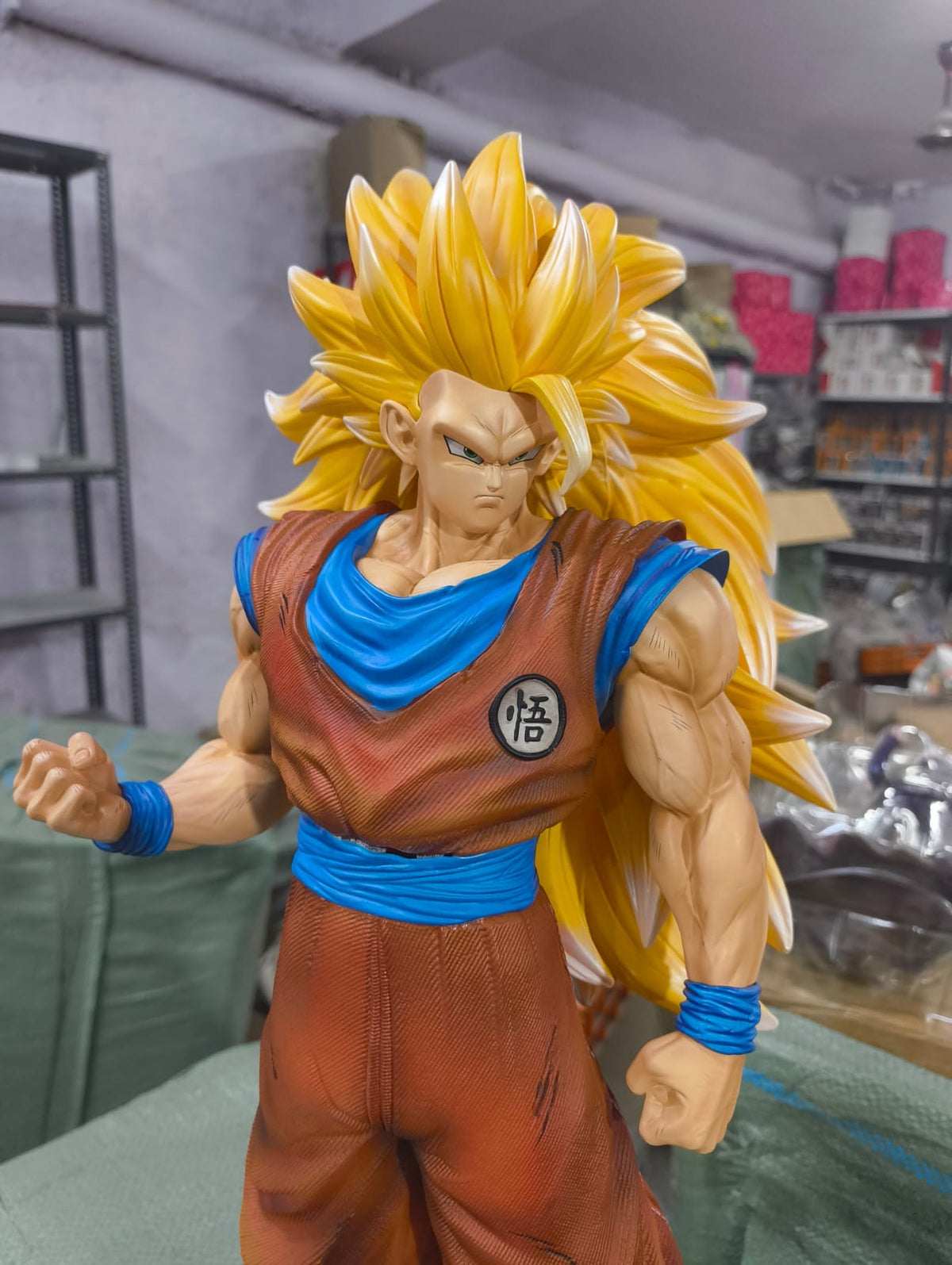 Actual Super Saiyan 3 Goku 50 cm figure close-up showing face sculpt, golden hair, chest emblem and paint detail
