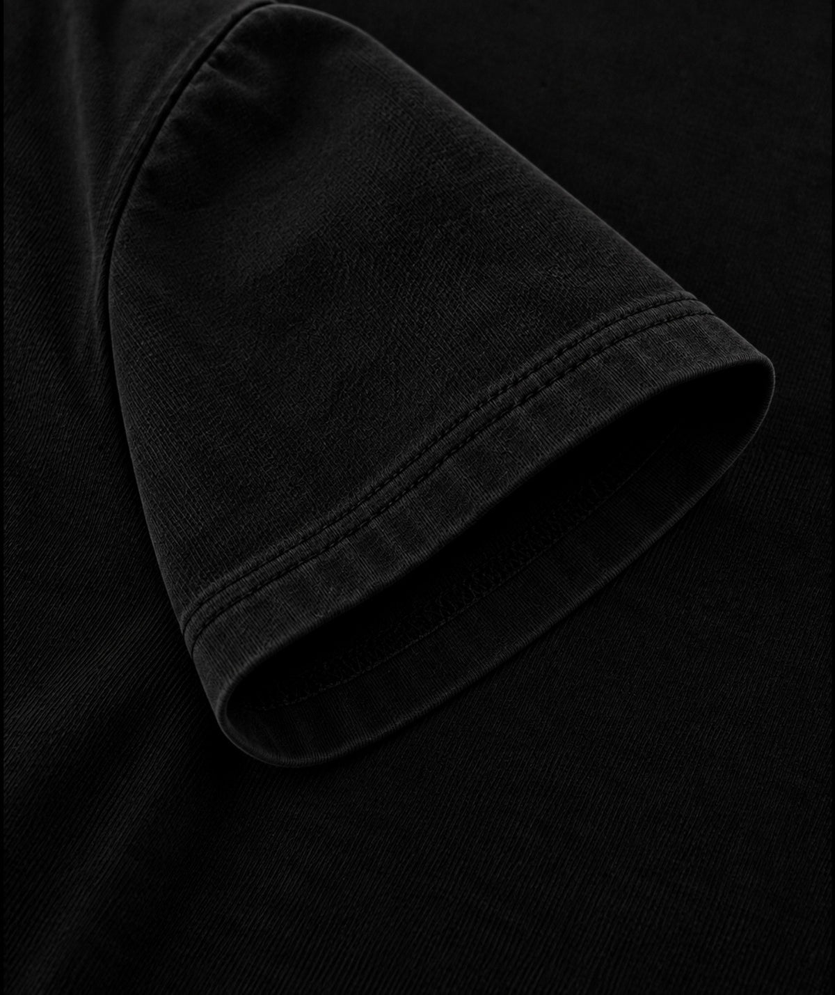 Black oversized T-shirt sleeve stitching and fabric close-up