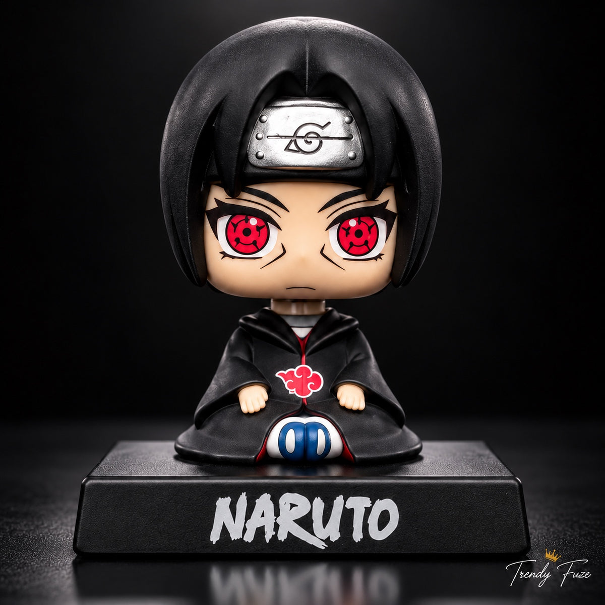 Itachi Uchiha anime collectible closeup showing Sharingan eyes, black hair, Akatsuki red cloud and Naruto stand