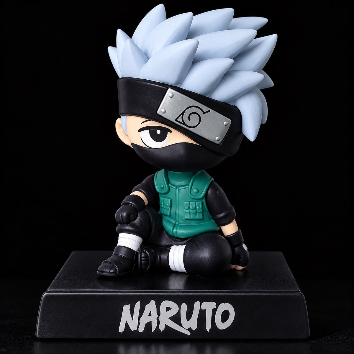 Kakashi Hatake sitting chibi anime bobblehead Naruto figure with silver spiky hair black face mask green ninja vest Hidden Leaf forehead protector and Naruto display base