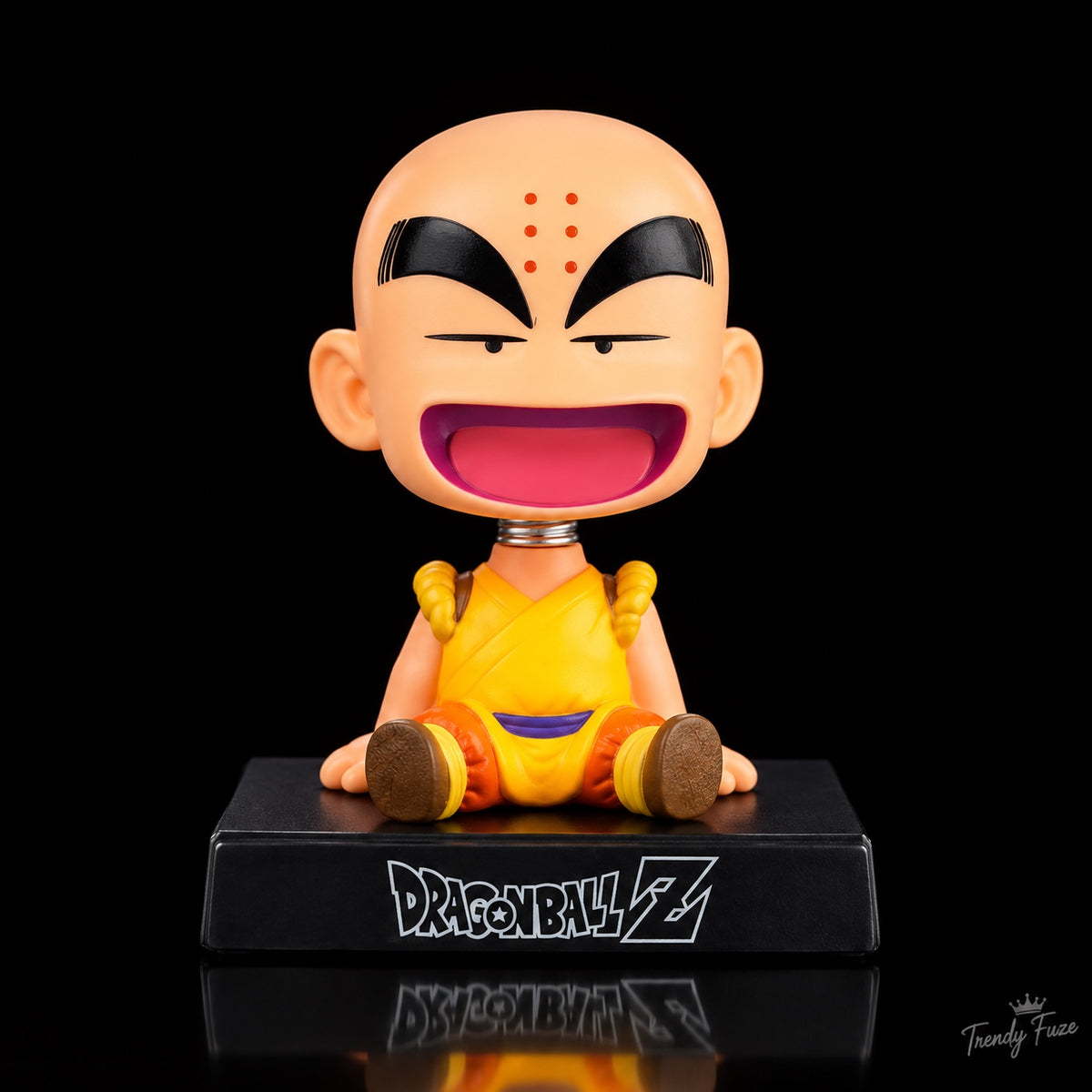 Krillin Dragon Ball Z seated anime bobblehead figure with six forehead dots, yellow orange monk outfit, spring neck and black Dragon Ball Z display base, front view