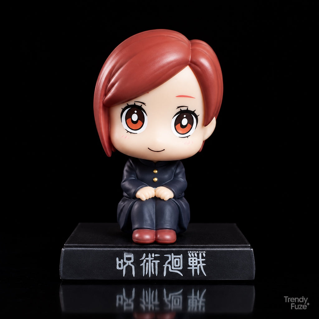 Nobara Kugisaki sitting Jujutsu Kaisen bobblehead-style anime figure with auburn bob-cut hair, black school uniform and red-brown shoes, front view