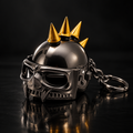 Imported spiked skull helmet metal keychain in gunmetal and gold on black background