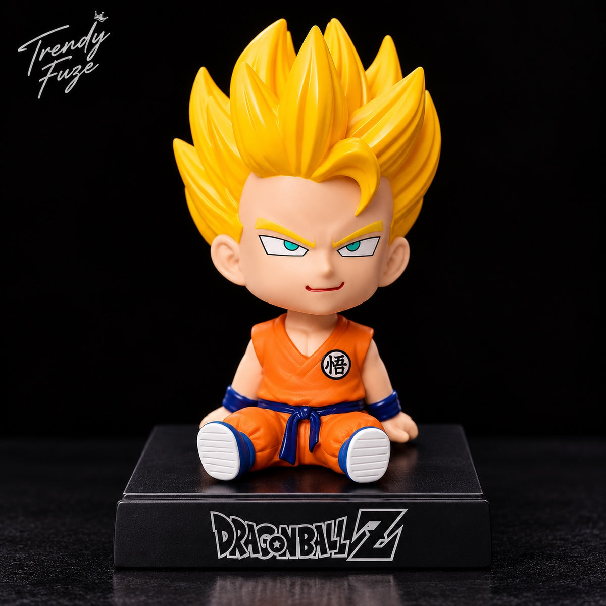 Super Saiyan Goku sitting Dragon Ball Z bobblehead figure with golden spiky hair, orange gi, blue wristbands, and Dragon Ball Z display stand