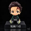 Tanjiro Kamado Demon Slayer sitting anime bobblehead figure in green and black checkered haori with forehead scar and black display base