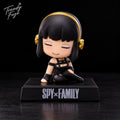 Yor Forger sitting anime bobblehead figure from Spy x Family wearing black outfit and gold hair accessories on black Spy Family display base