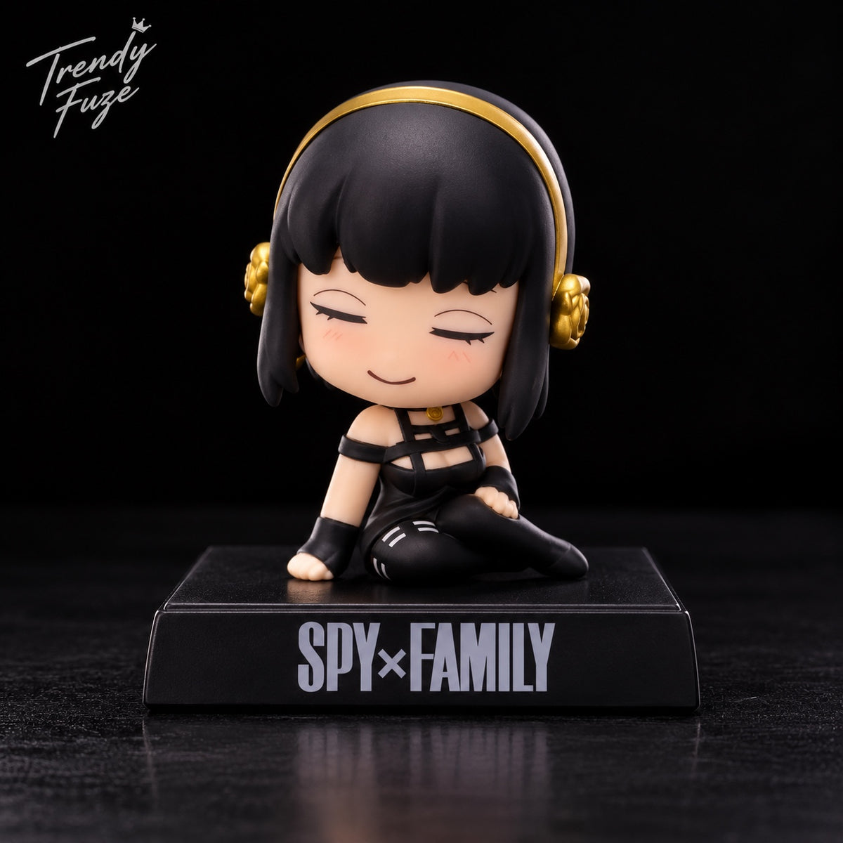 Yor Forger sitting anime bobblehead figure from Spy x Family wearing black outfit and gold hair accessories on black Spy Family display base