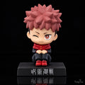 Yuji Itadori Jujutsu Kaisen sitting bobblehead figure front view with pink spiky hair, black uniform, red hood, winking expression and display base