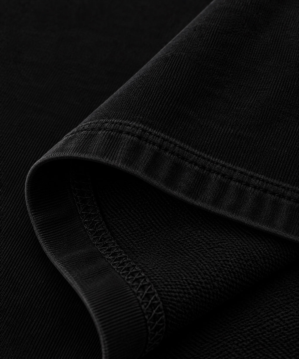 Black T-shirt fabric texture and seam close-up