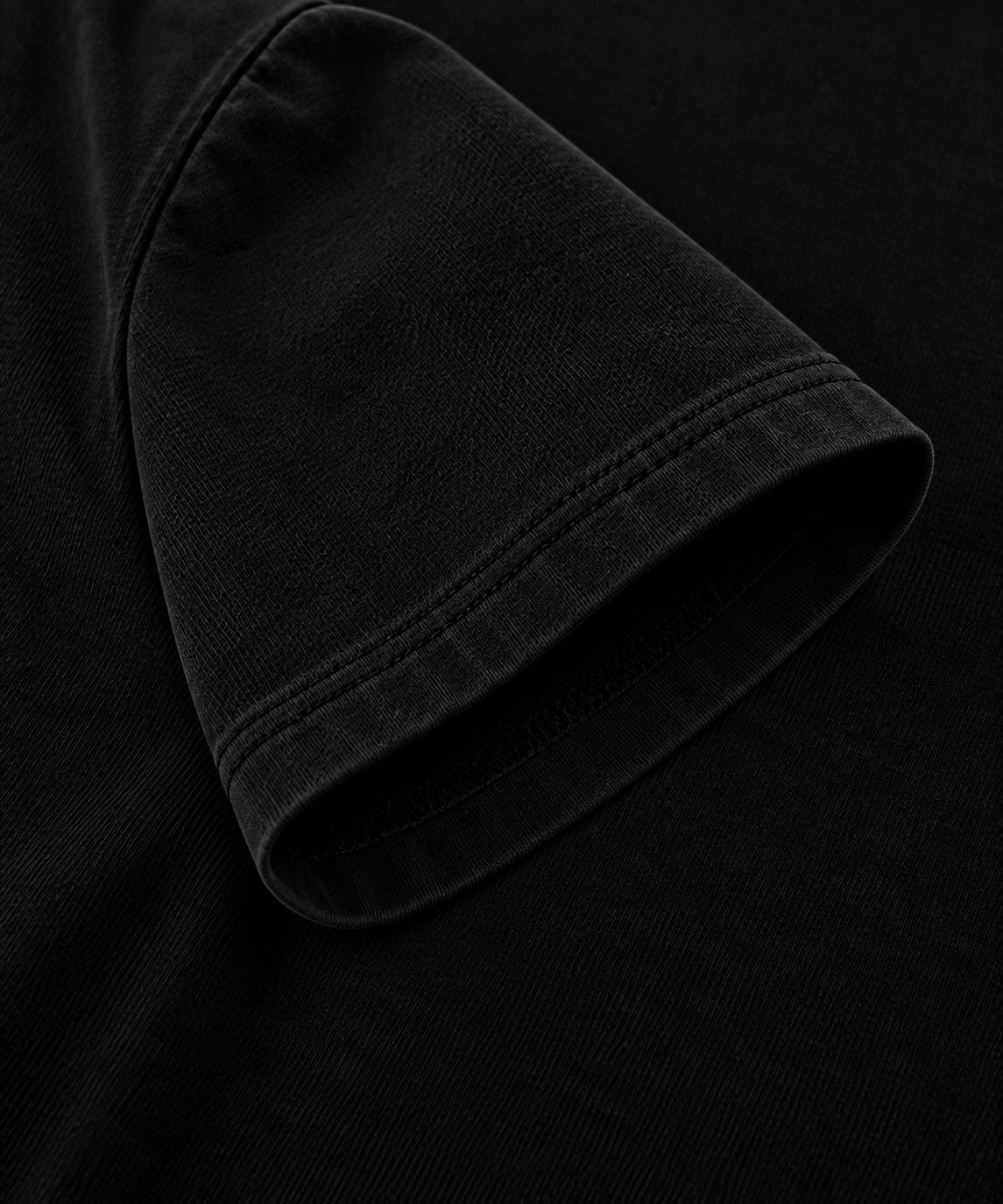 Black oversized T-shirt sleeve and stitching close-up